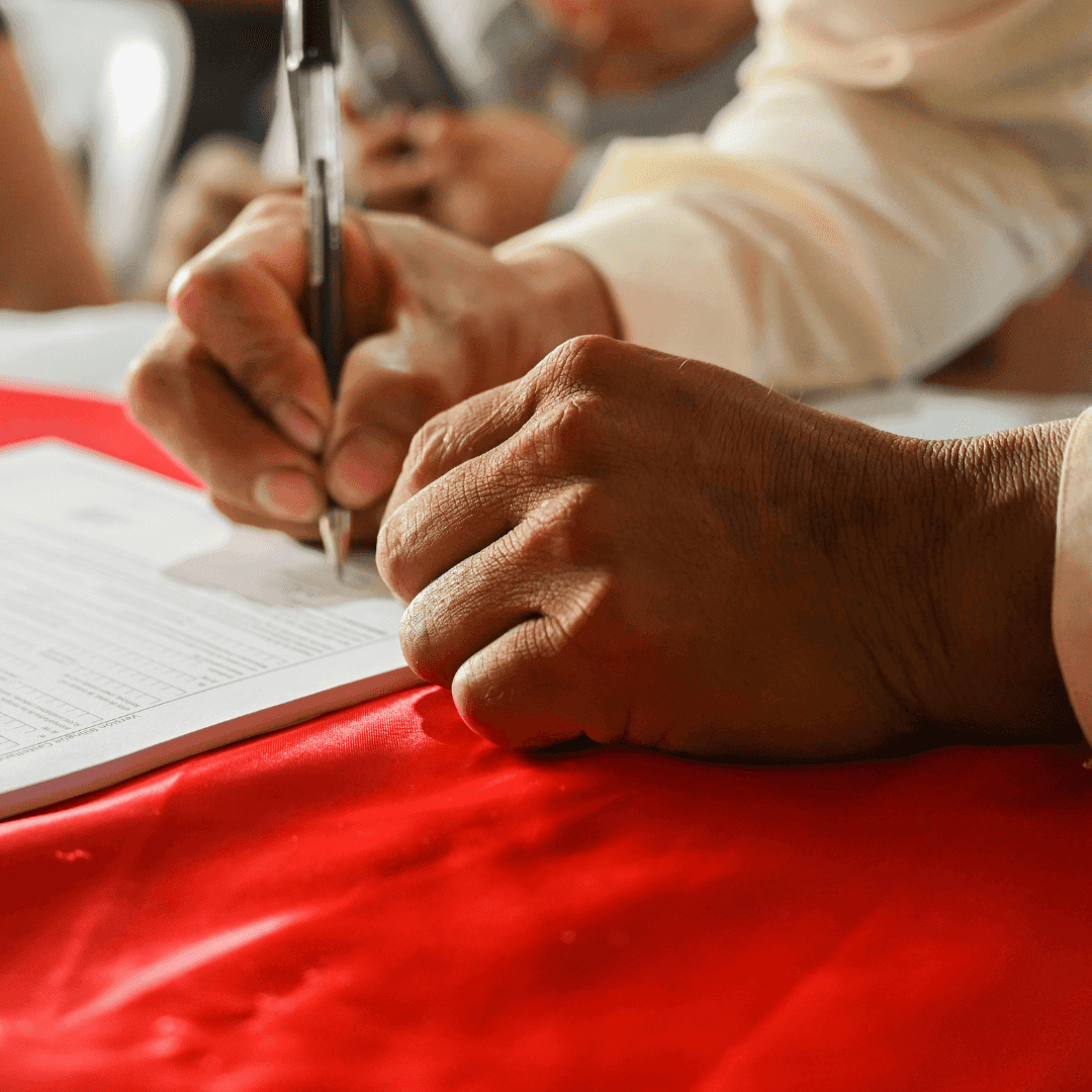 Hands signing a legal document.