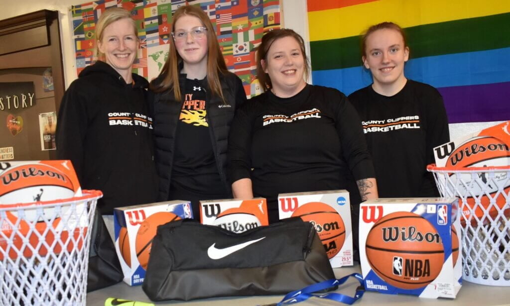 women smiling with basketballs