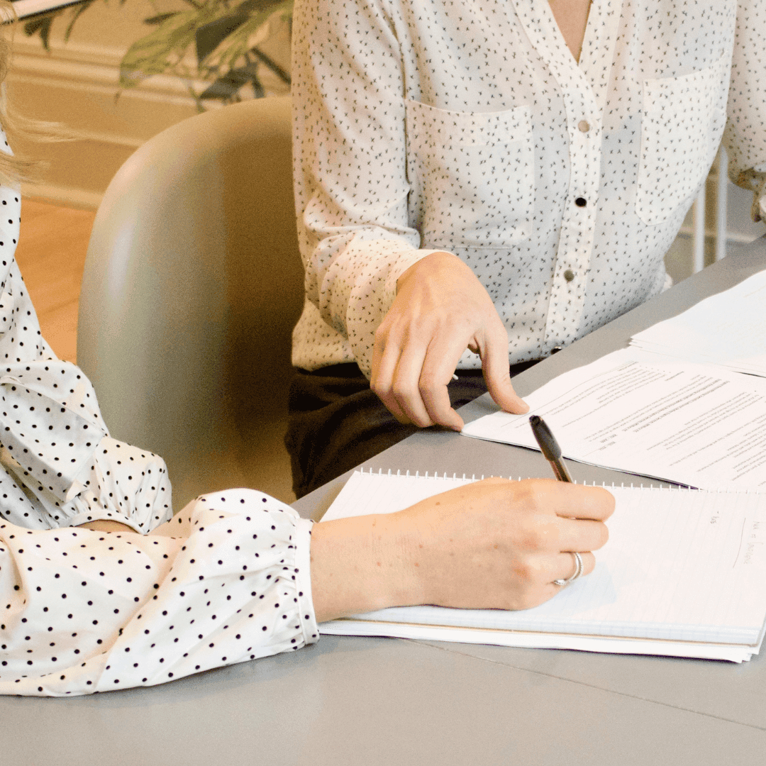 Two people reviewing legal documents.