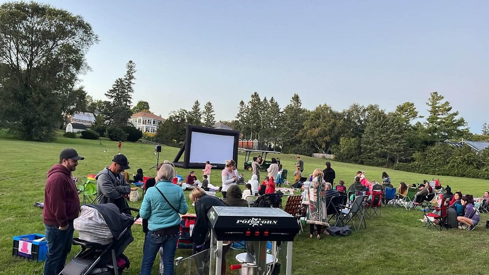 screen in park with families watching