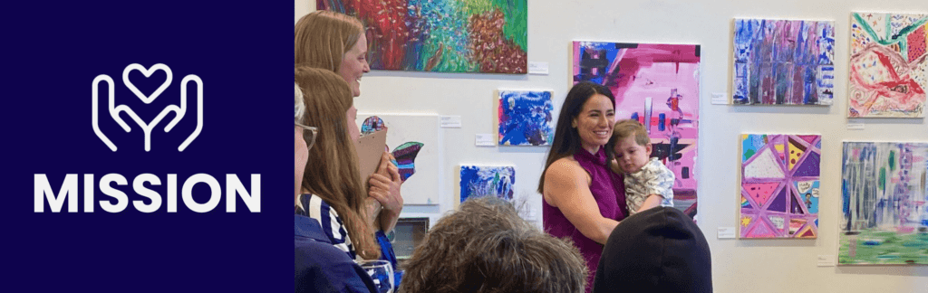 executive director addressing crowd with art in background