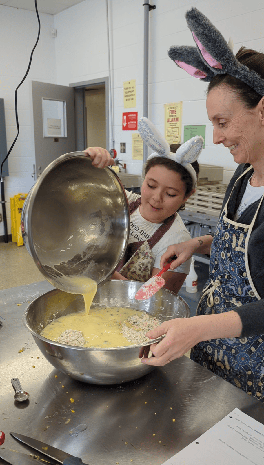 girl with bunny ears pouring batter