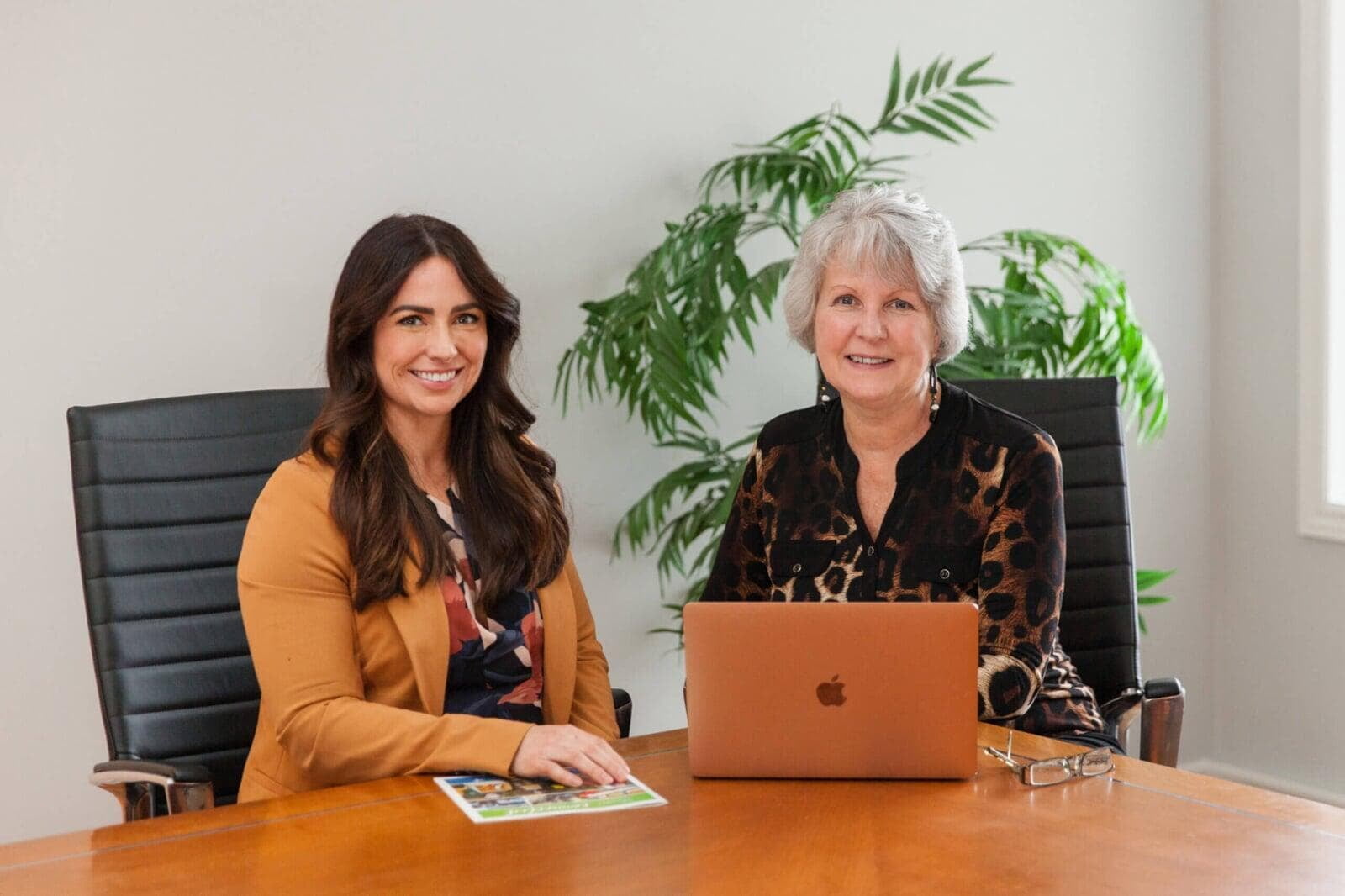 Dominique Jones, Executive Director, and Anne VanVlack, Vital Signs Coordinator, sitting at a desk and smiling.