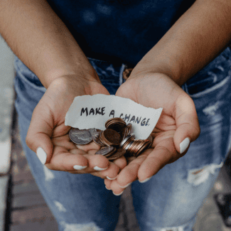 Hands holding coins and a note saying "make a change".