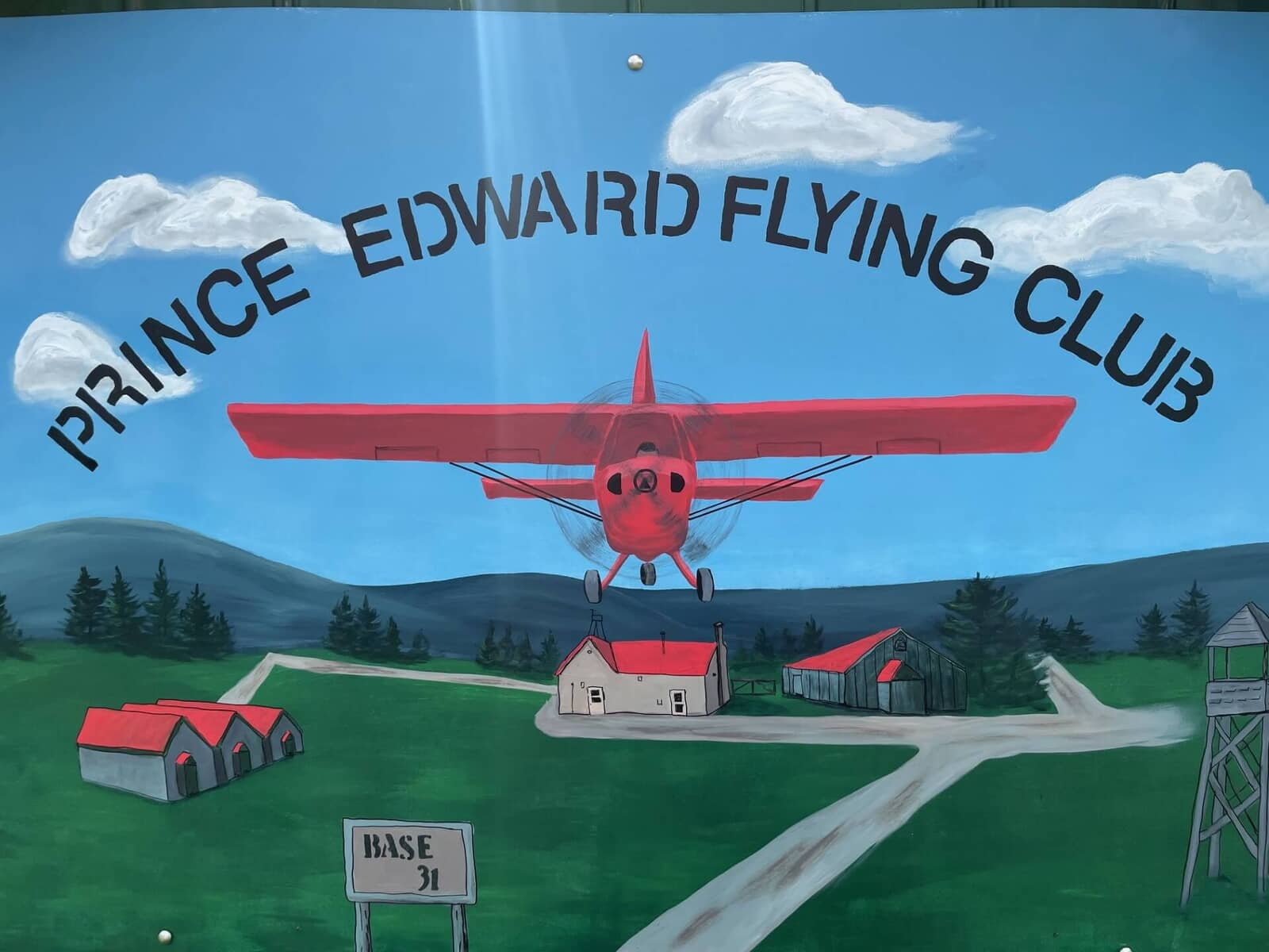 Art of flying plane with Prince Edward Flying Club written above.