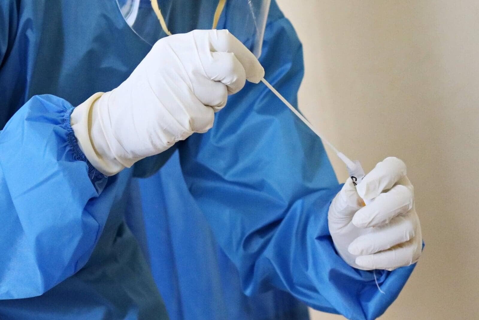 Healthcare worker taking a swab.